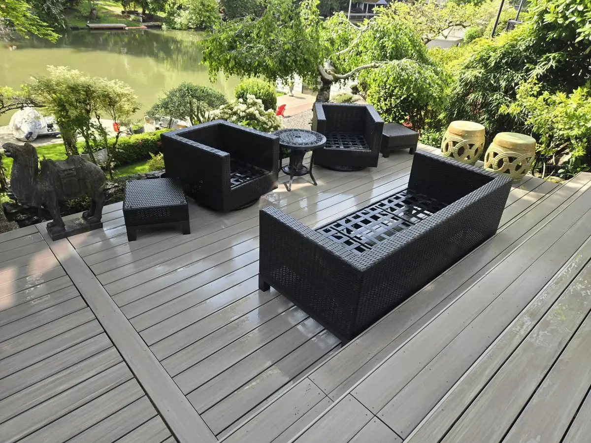 Freshly washed composite deck with patio furniture overlooking a pond